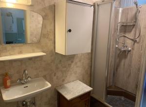 a bathroom with a sink and a shower with a mirror at Ferienwohnung Durst 2 in Mayrhofen +22 photos