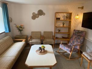 a living room with a couch and chairs and a table at Ferienwohnung Durst 2 in Mayrhofen