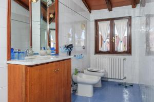 a bathroom with a sink and a toilet and a mirror at Camere La Ro Ca- Telti in Telti +24 photos