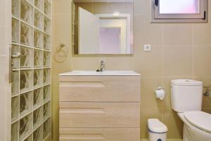 a bathroom with a sink and a toilet and a mirror at Ca Luis in Mogán +13 photos