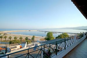 a balcony with a view of a body of water at A View From The Attic Window in Kyparissia