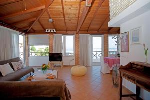 a living room with a couch and a table at A View From The Attic Window in Kyparissia