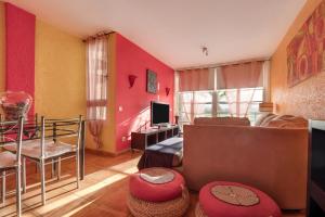 a living room with a couch and a television at La Casa De Enzo in Playa de las Americas