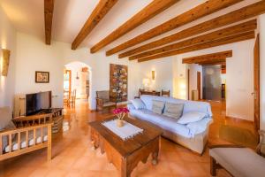 a living room with a couch and a coffee table at Can Xisco in Artá