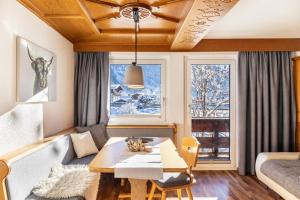 a living room with a table and a couch at Berggold in Nesselwängle