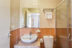 a bathroom with a sink and a toilet and a mirror at Par3 in Oliva +20 photos
