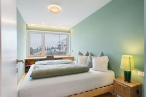 a bedroom with a white bed and a window at Casa Zar Ferienwohnung in Verano
