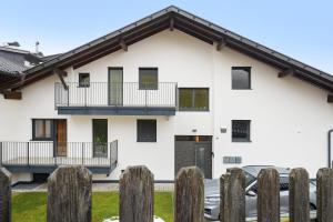 a white house with balconies and a fence at Casa Zar Ferienwohnung in Verano