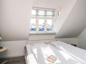 a bed in a room with a window at 2-room apartment in Denmark in Ringkøbing