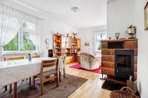 a living room with a table and a fireplace at Ferienhaus Feldblick in Karwitz