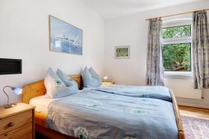 a bedroom with a bed and a window at Ferienhaus Feldblick in Karwitz