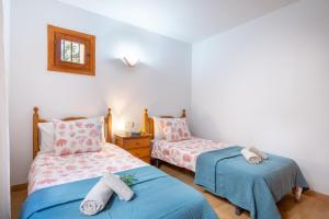 a bedroom with two beds and a window at Vistasol Port de Soller in Sóller +17 photos