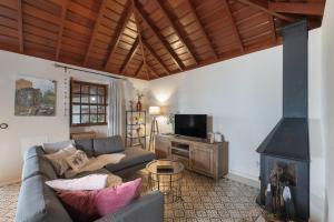 a living room with a couch and a fireplace at El Bebedero de Los Sauces in San Andres y Sauces