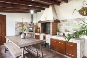 a kitchen with a wooden table and a stove at El Bebedero de Los Sauces in San Andres y Sauces