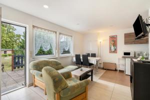 a living room with a couch and a table at Bungalow 91 in Zeulenroda