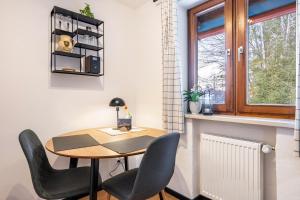 a small table and chairs in a room with a window at Fewo Am Steinbach - Lofer in Reit im Winkl