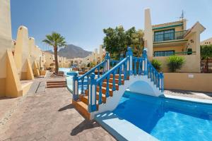 a slide in the middle of a swimming pool at Beach Holidays in Adeje