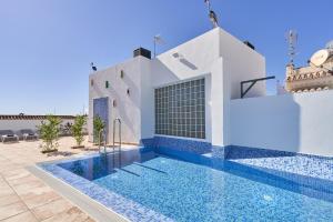 a swimming pool in front of a white building with a swimming pool at Nerja Boutique 202 Deluxe in Nerja +16 photos