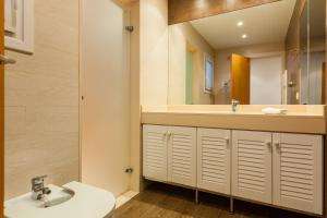 a bathroom with a sink and a mirror at Lemon Tree Apartment in Canet de Mar +16 photos