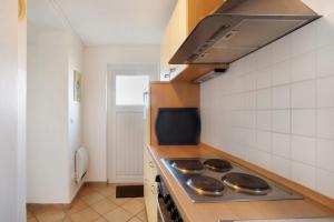 a kitchen with a stove top oven in a room at Birkethof Studio in Mickhausen +21 photos