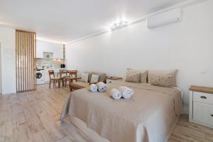 a bedroom with a bed with two pillows on it at White Studio and Terrace in Albufeira +26 photos