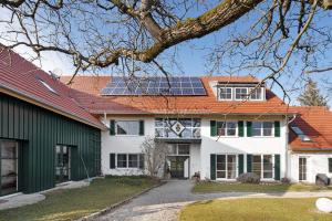 a house with solar panels on the roof at Birkethof Studio in Mickhausen
