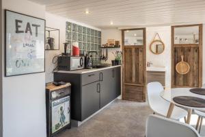 a kitchen with a table and a dining room at Modernes Landapartment in Seevetal