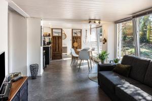 a living room with a couch and a table at Modernes Landapartment in Seevetal