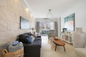 a living room with a couch and a table at Private Villa Candelaria in Candelaria