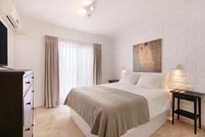 a white bedroom with a bed and a window at Private Villa Candelaria in Candelaria +37 photos