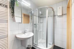 a white bathroom with a sink and a shower at Ferienwohnung Kraus in Katzenbach +12 photos