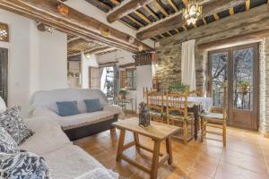 a living room with a couch and a table at Casa El Portón, Bubión in Bubión