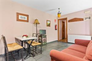 a living room with a couch and a table at Puente del Narcea 1 in Cibuyo