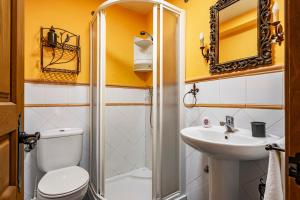 a small bathroom with a toilet and a sink at Puente del Narcea 1 in Cibuyo +24 photos