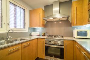 a kitchen with a stove and a sink at Canet beach 3 in Canet de Mar
