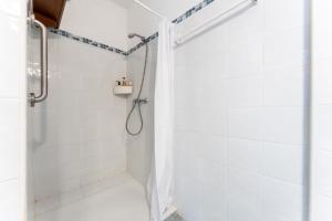 a shower with a shower curtain in a bathroom at Ventana al mar in Fuengirola +13 photos