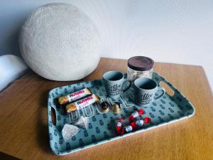 a tray on a table with two cups and medicines at Studio Pergaud in Besançon