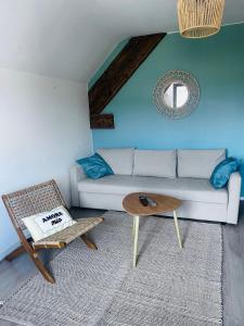 a living room with a couch and a table at Studio Pergaud in Besançon +1 photo