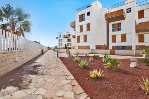 a stone walkway in front of a building at Edificio Los Martines in El Médano