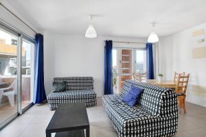 a living room with two chairs and a table at Edificio Los Martines in El Médano