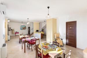 a dining room with a table and chairs at Coast 2 Coast in Agerola