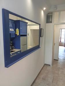 a mirror on the wall of a kitchen at Le Royal in Bayeux