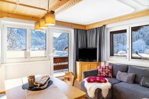 a living room with a couch and a table at Berggold in Nesselwängle