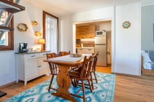 a kitchen and dining room with a wooden table and chairs at Villa Balbi in Torre delle Stelle