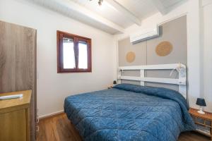 a bedroom with a blue bed in a room at Villa Balbi in Torre delle Stelle