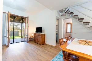 a living room with a dining table and a tv at Villa Balbi in Torre delle Stelle