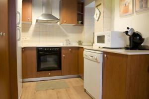 a kitchen with a microwave and a stove top oven at Ço de Carles in Garós