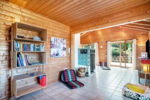 a room with a book shelf and chairs in a cabin at Landhaus-Eifelhöhe in Schüller
