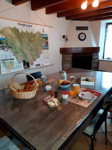 a table with breakfast foods on it in a kitchen at Chambre et Table d’Hôtes du Terroir in Borne