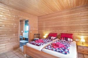 a bedroom with a bed in a wooden room at Landhaus-Eifelhöhe in Schüller